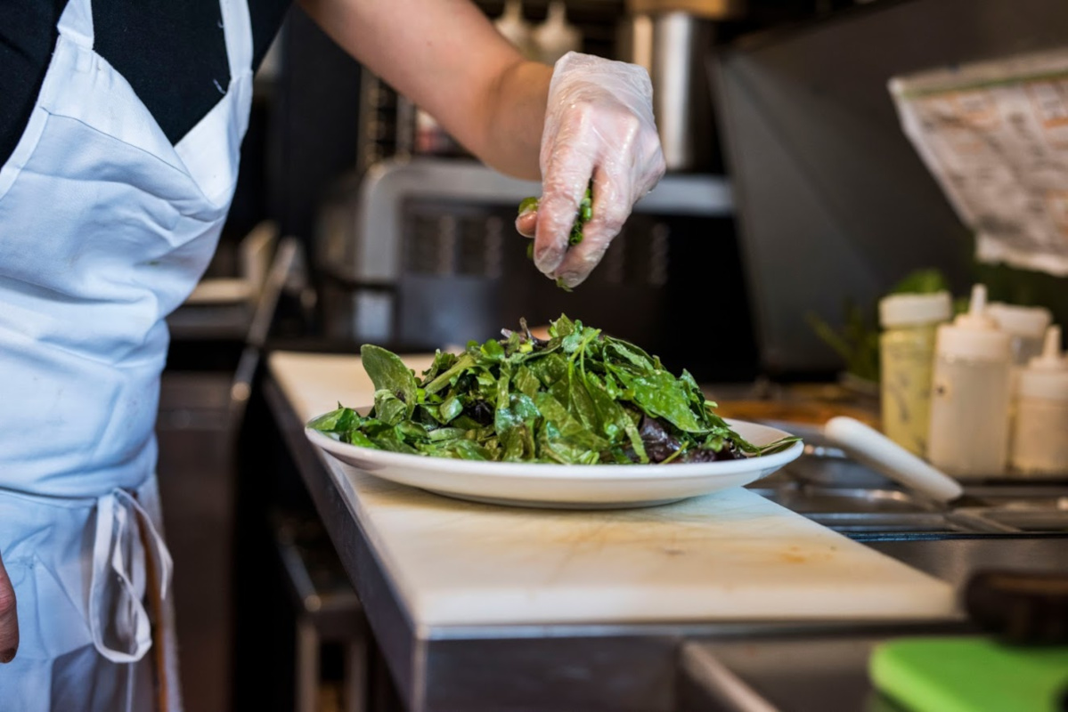 An employee making a salad